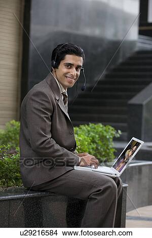 Executive working on his laptop View Large Photo Image Picture - Executive working on his laptop. Fotosearch