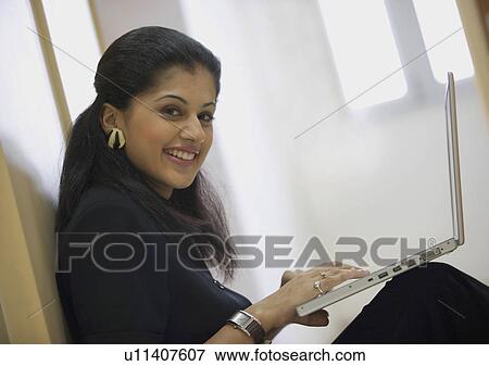 Stock Photo - Executive working on laptop. Fotosearch