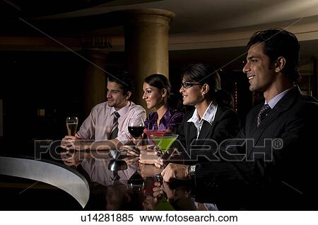 Stock Photography - Executives at the bar. Fotosearch