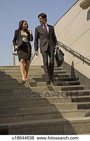 Stock Photo - Executives climbing down the stairs. Fotosearch