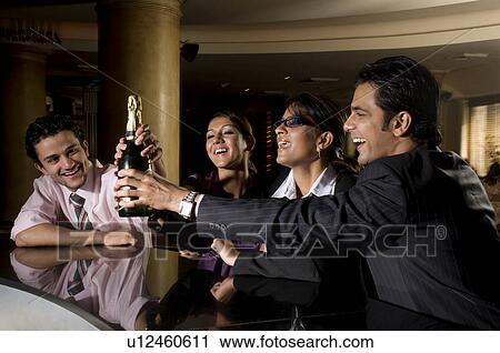 Stock Image - Executives holding a bottle. Fotosearch