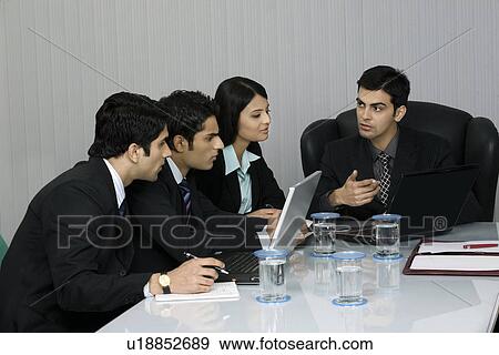 Executives in a meeting View Large Photo Image Stock Photo - Executives in a meeting . Fotosearch
