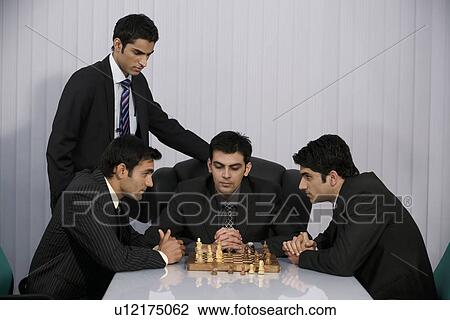 Stock Image - Executives playing chess. Fotosearch