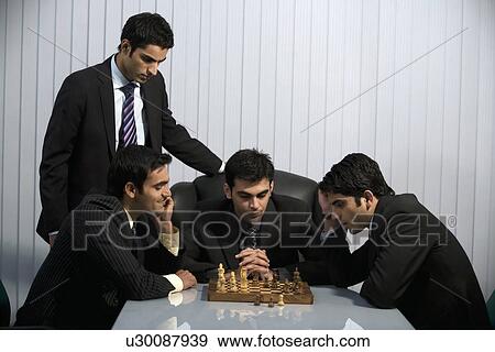 Stock Photo - Executives playing chess. Fotosearch