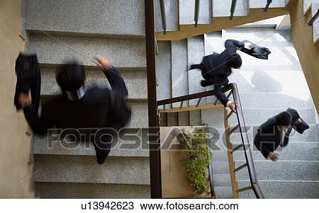 Executives running up the stairs View Large Photo Image Stock Image - Executives running up the stairs. Fotosearch