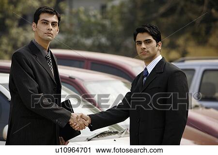 Stock Image - Executives sealing the deal. Fotosearch