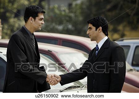 Stock Image - Executives sealing the deal . Fotosearch