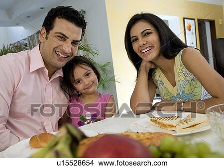 Family at the dinning table View Large Photo Image Picture - Family at the dinning table. Fotosearch