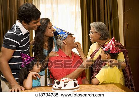 Stock Photography - Family celebrating a birthday. Fotosearch