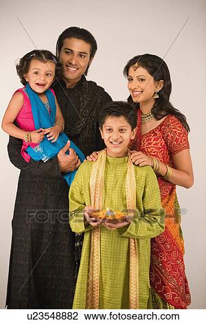 Family celebrating diwali View Large Photo Image Stock Image - Family celebrating diwali. Fotosearch