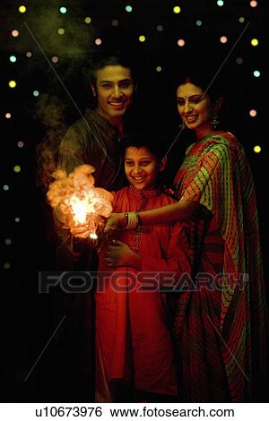 Stock Photograph - Family celebrating Diwali. Fotosearch