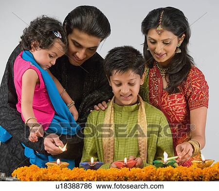 Stock Photograph - Family celebrating diwali. Fotosearch