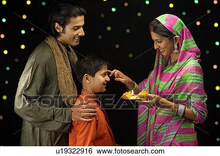 Family celebrating festival View Large Photo Image Stock Photograph - Family celebrating festival. Fotosearch