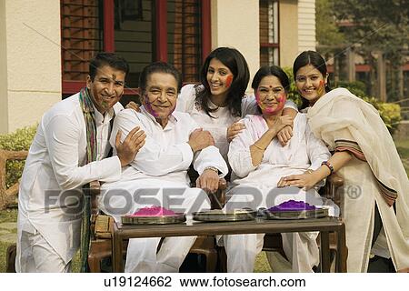 Stock Image - Family celebrating Holi. Fotosearch