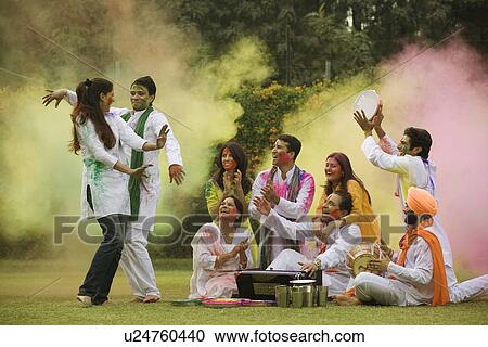Stock Image - Family celebrating Holi. Fotosearch
