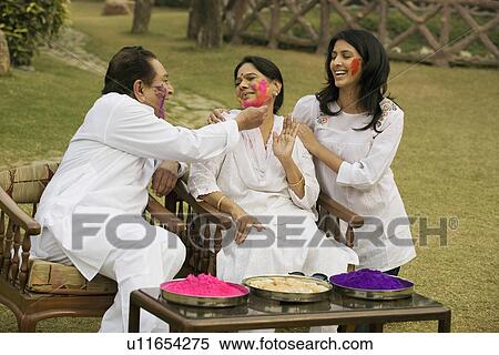 Stock Photography - Family celebrating Holi. Fotosearch