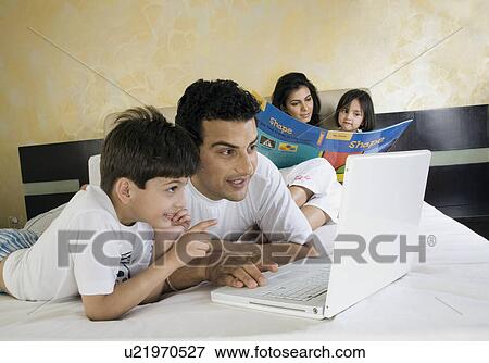 Family in the bedroom View Large Photo Image Stock Photo - Family in the bedroom. Fotosearch