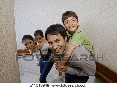 Family posing on the stairs View Large Photo Image Stock Photo - Family posing on the stairs. Fotosearch