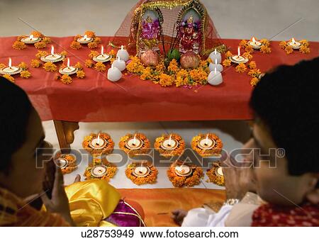 Family praying on Diwali View Large Photo Image Stock Photo - Family praying on Diwali. Fotosearch
