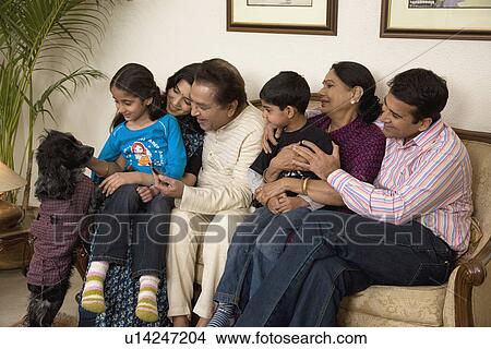 Picture - Family sitting together. Fotosearch