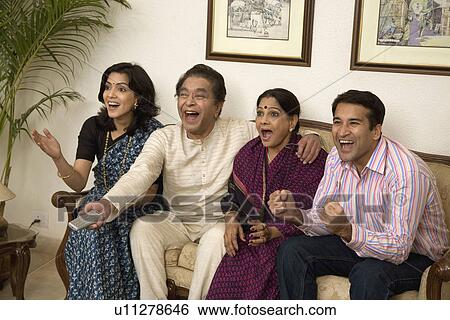 Stock Photograph - Family watching T. V.. Fotosearch