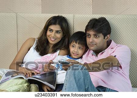 Stock Image - Family watching television. Fotosearch