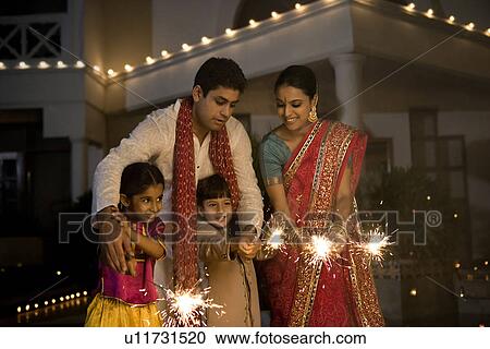 Family with fireworks on Diwali evening View Large Photo Image Stock Image - Family with fireworks on Diwali evening. Fotosearch