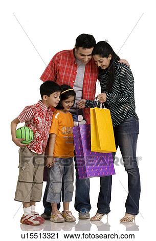 Stock Image - Family with shopping bags. Fotosearch