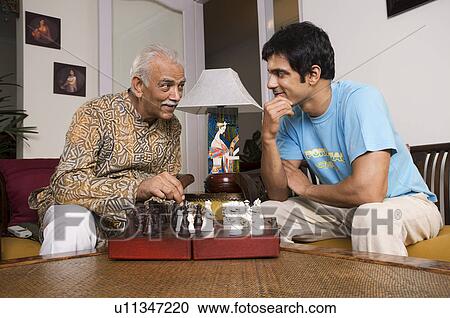 Father and son playing chess View Large Photo Image Stock Image - Father and son playing chess. Fotosearch