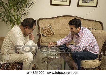 Father and son playing chess View Large Photo Image Stock Image - Father and son playing chess. Fotosearch