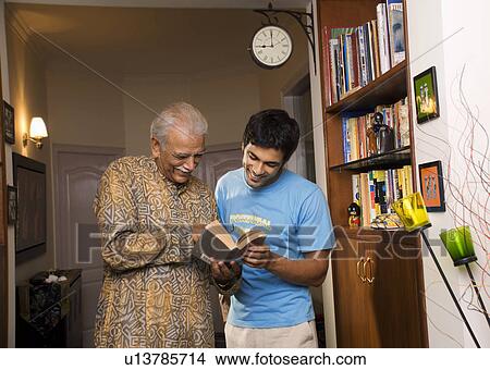 Picture - Father and son reading a book. Fotosearch