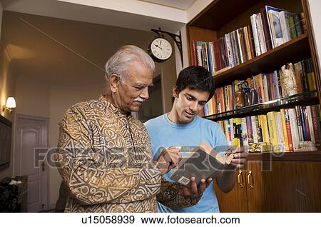 Stock Photo - Father and son reading a book. Fotosearch