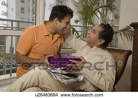Picture - Father patting his son's head. Fotosearch