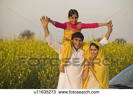 Stock Image - Father with daughter on his shoulders. Fotosearch