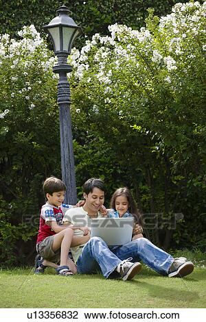 Stock Image - Father with his kids. Fotosearch