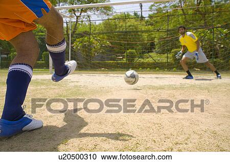 Footballer aims for the goal View Large Photo Image Stock Image - Footballer aims for the goal. Fotosearch