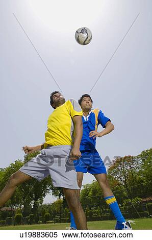 Footballers try to get a header View Large Photo Image Stock Photography - Footballers try to get a header. Fotosearch