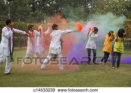 Stock Photo - Friends celebrating Holi. Fotosearch