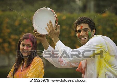 Stock Photo - Friends celebrating Holi. Fotosearch