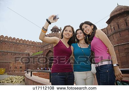Stock Photo - Friends clicking their photograph. Fotosearch