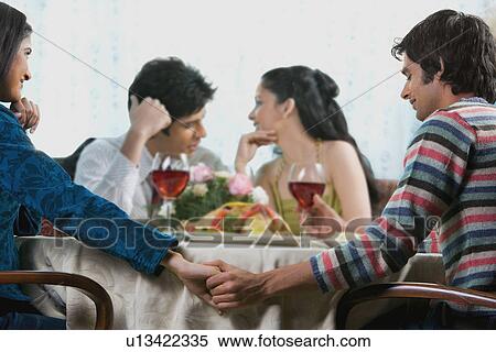 Friends enjoying a meal View Large Photo Image Stock Photography - Friends enjoying a meal. Fotosearch