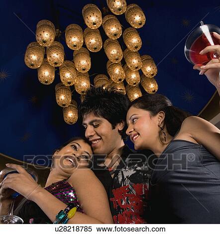 Stock Photography - Friends enjoying their drink. Fotosearch