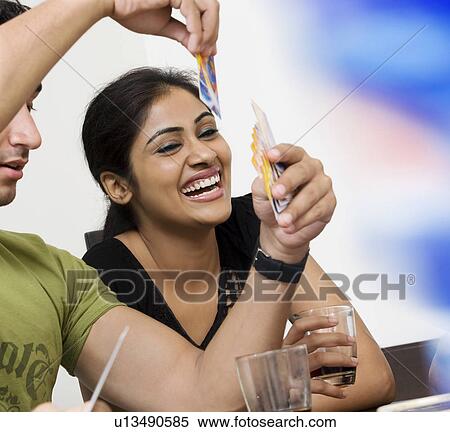 Stock Photography - Friends playing cards. Fotosearch