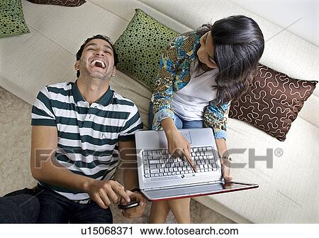 Stock Image - Friends sharing a joke. Fotosearch