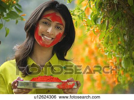 Girl holding a plate of colour View Large Photo Image Stock Photograph - Girl holding a plate of colour. Fotosearch