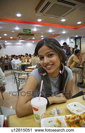 Stock Image - Girl in a food joint. Fotosearch