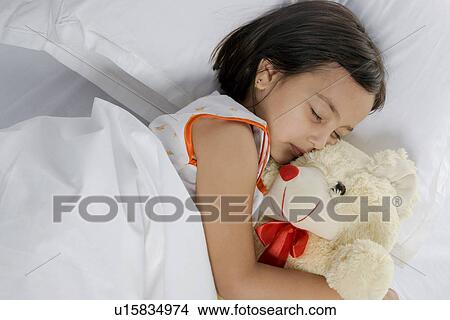 Picture - Girl sleeping with her teddy bear. Fotosearch