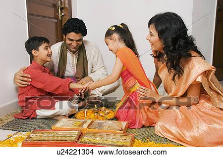 Girl tying a rakhi View Large Photo Image Picture - Girl tying a rakhi. Fotosearch