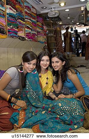 Girls at a garment shop View Large Photo Image Stock Photo - Girls at a garment shop. Fotosearch