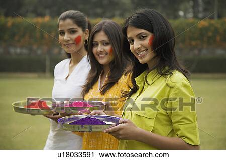 Stock Image - Girls celebrating Holi. Fotosearch